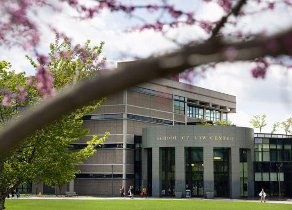 Outside of the School of Law building in the spring