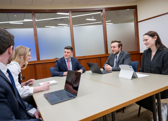 Brendan Holt sitting with students