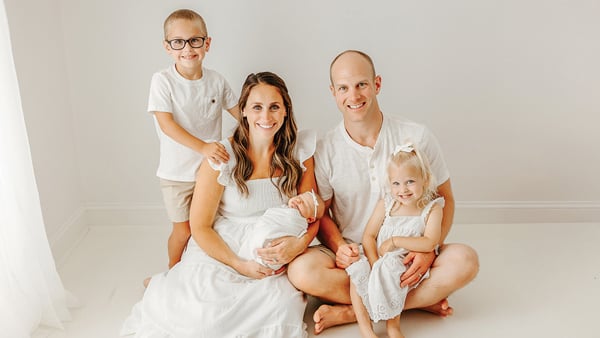 Keith Yatauro and Erica Yatauro pose for a photo with their two young children and new infant