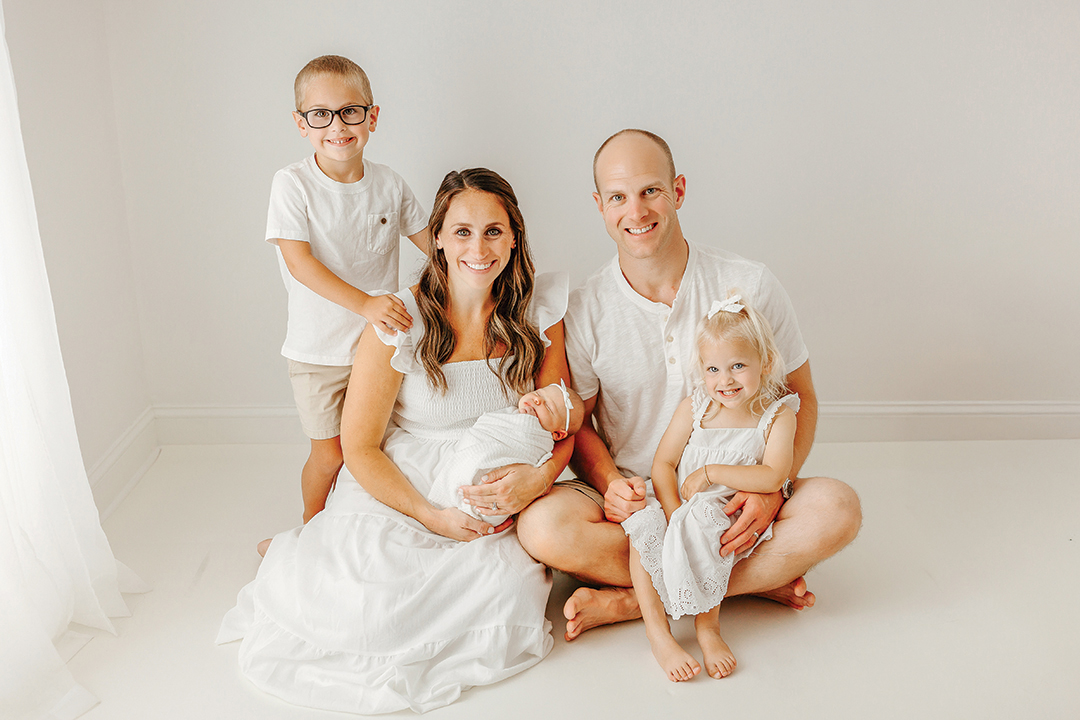 Keith Yatauro and Erica Yatauro pose for a photo with their two young children and new infant
