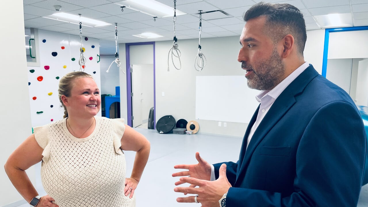 Two Quinnipiac occupational therapy alumni talk together in a bright, cheerful room